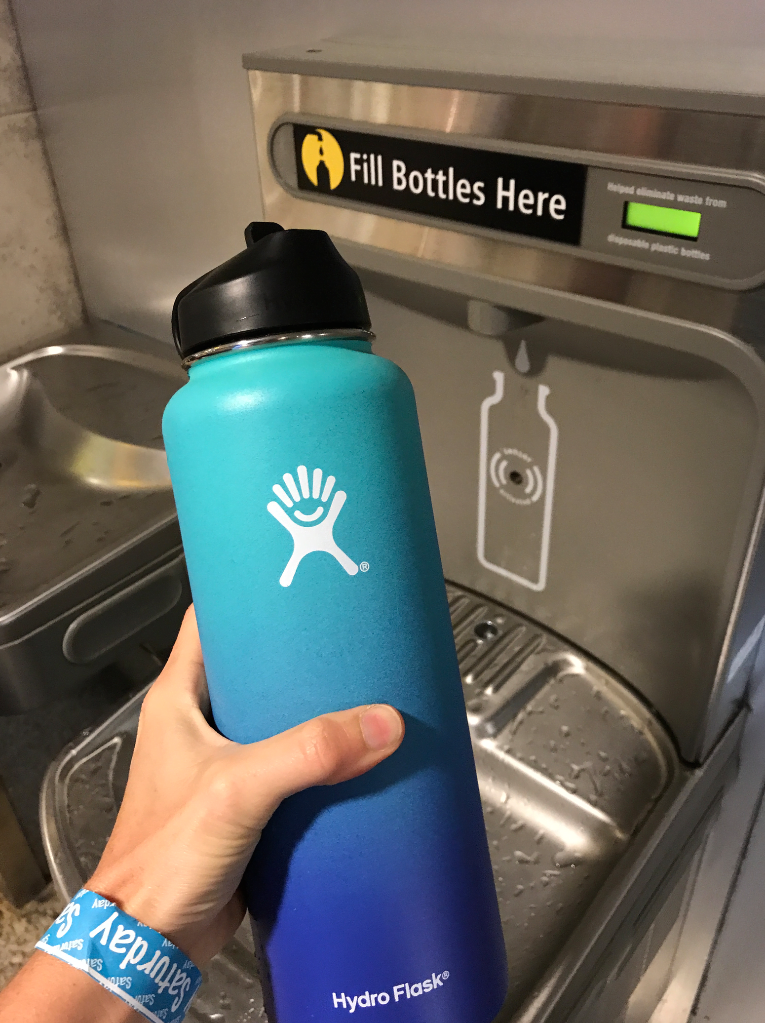 Hydro Flask filling up water bottle at the airport 