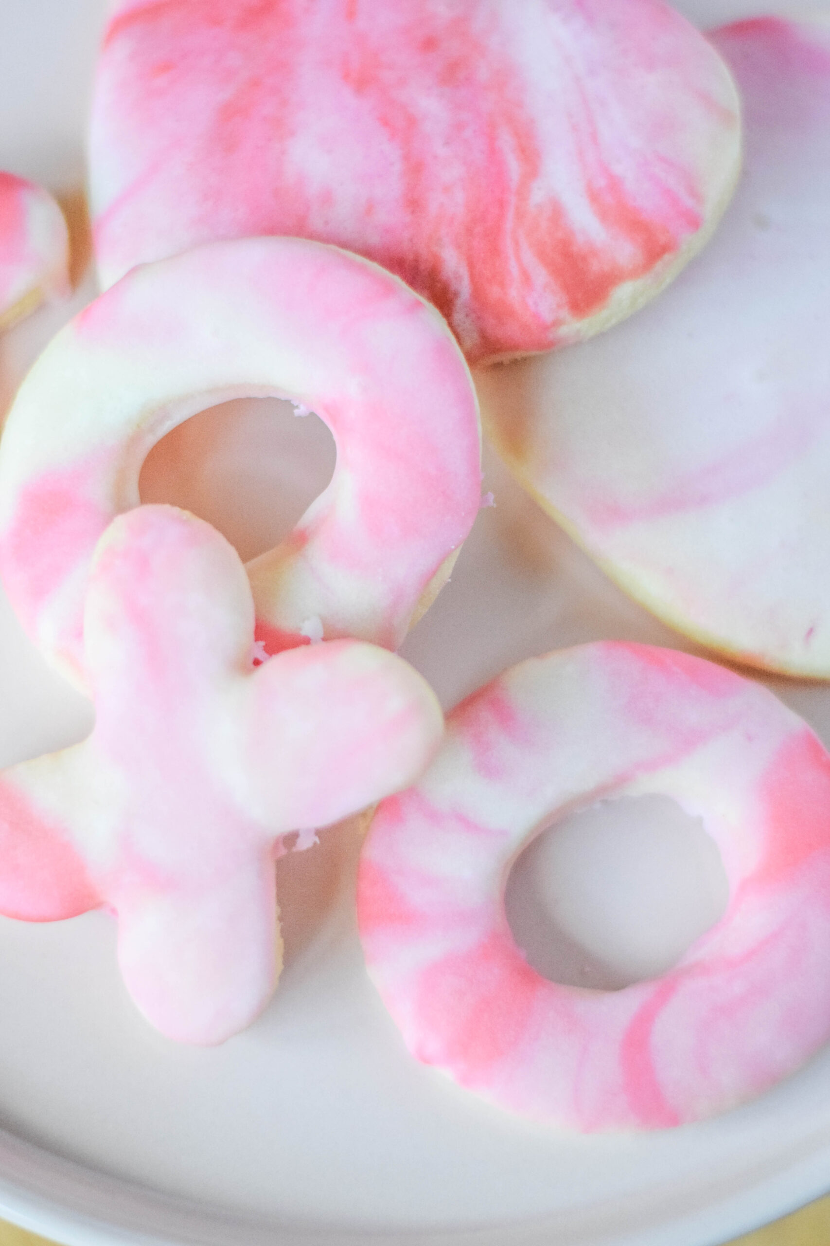 XOXO sugar cookies with red, pink, and white marble icing