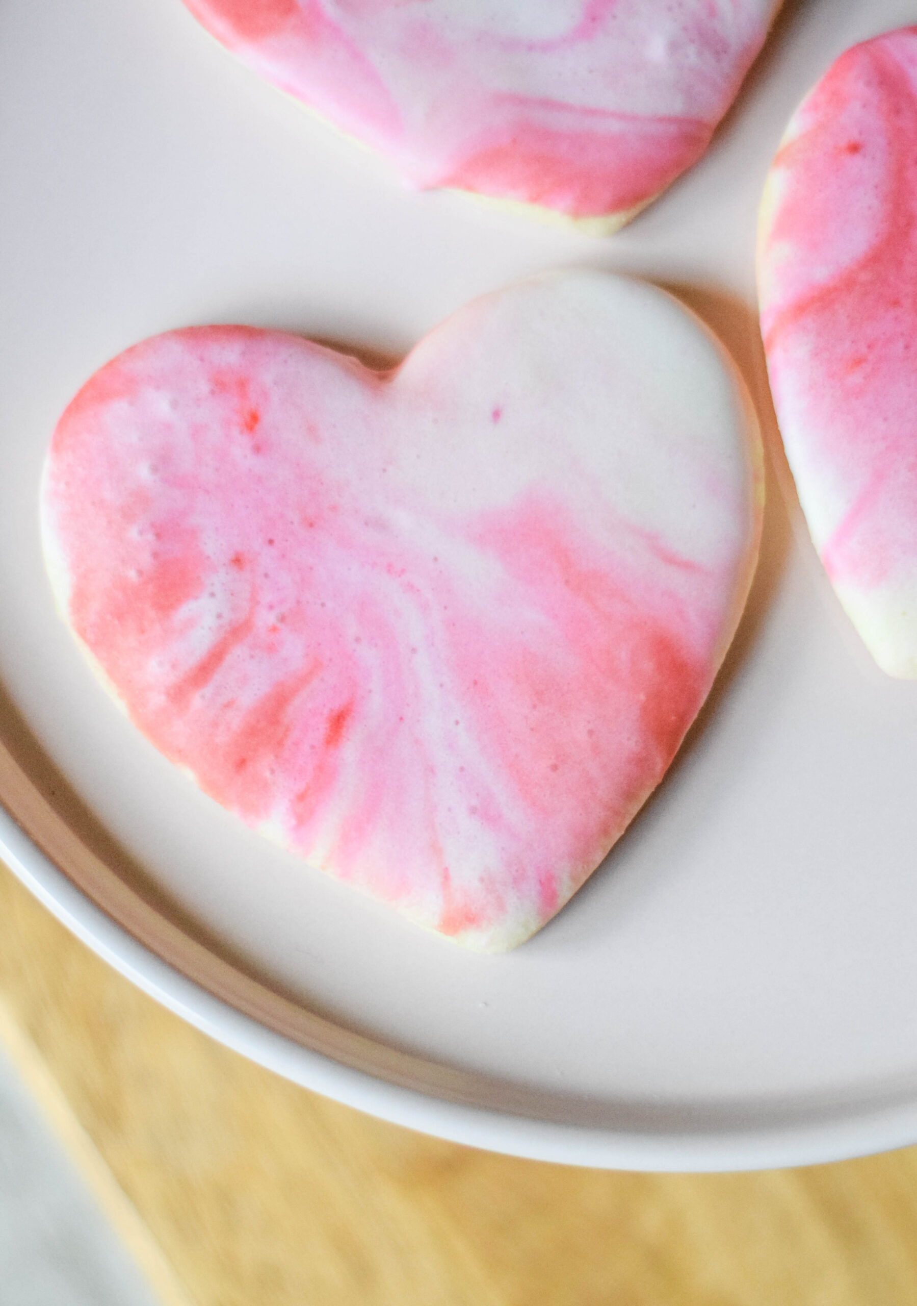 Heart shaped sugar cookies with pink, red, and white icing